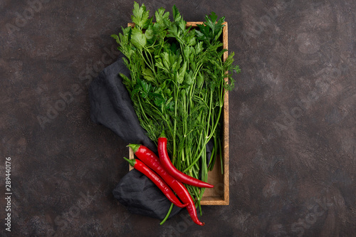 fresh greens and chilli peppers on a lilac background