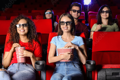 Friends with popcorn watching movie in cinema © Pixel-Shot
