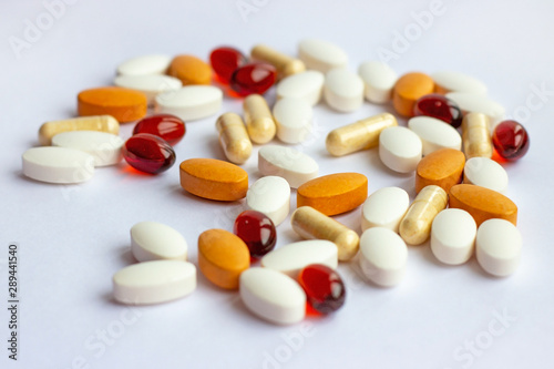 Many different pharmaceutical medicine pills, tablets and capsules on white background. Pharmacy theme, health care, drug prescription for treatment medication and medicament