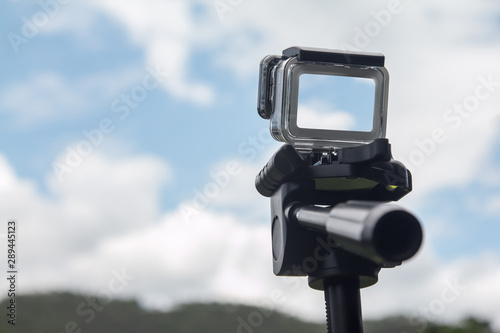 digital action camera shooting photo and video recording beautiful blue sky.  photography