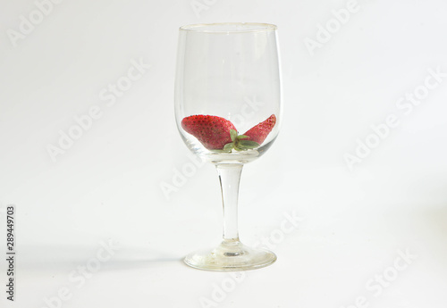 Strawberry in wine glass on white background