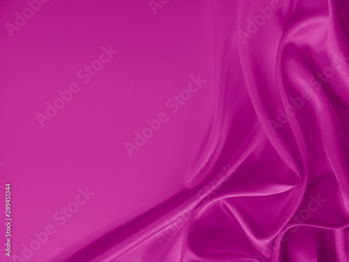 Beautiful smooth elegant wavy hot pink satin silk luxury cloth fabric texture, abstract background design. 