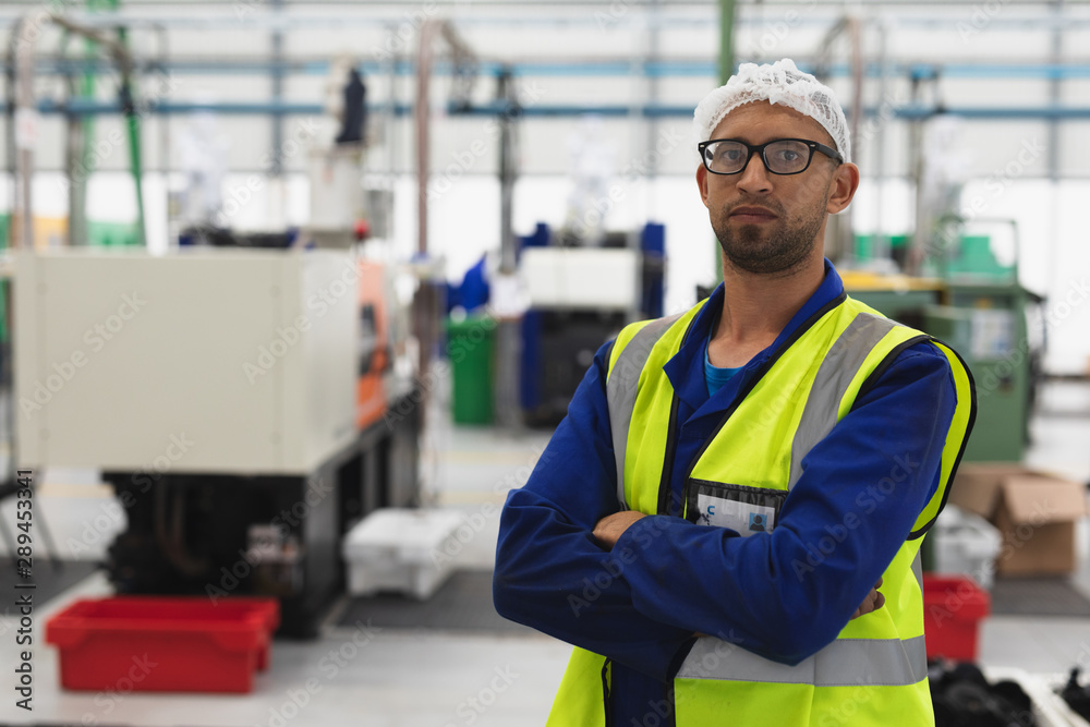 Portrait of a male factory worker in a factory warehouse Portrait of a male factory worker in a factory warehouse