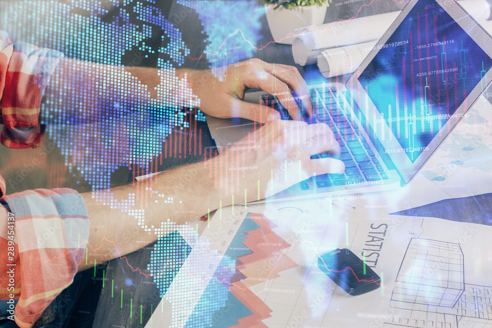 Double exposure of stock graph with businessman typing on computer in office on background. Concept of hard work. Double exposure of stock graph with businessman typing on computer in office on background. Concept of hard work.