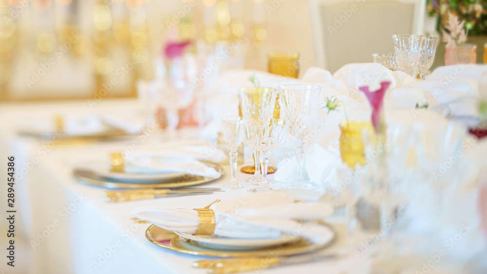 Fototapeta premium Elegant dinner table set with silverware, napkin and glass at restaurant before party