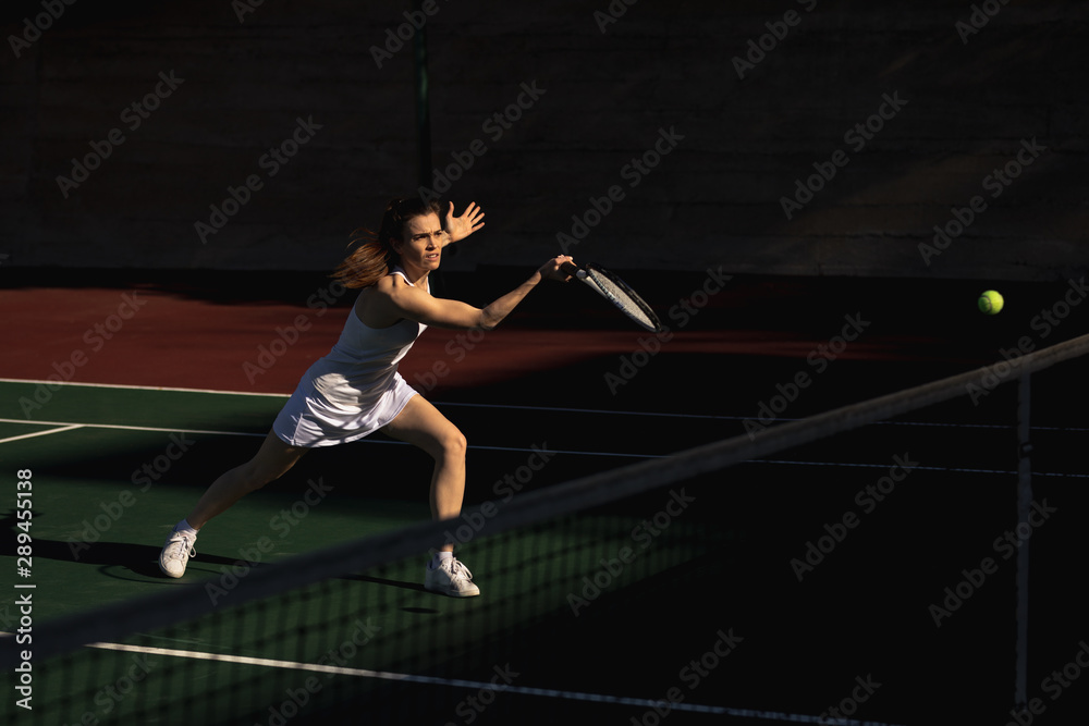 Woman playing tennis on a sunny day Woman playing tennis on a sunny day