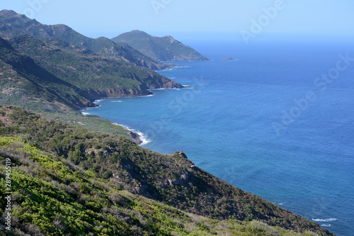 view of mountains and sea in the coastline of Sardinia, from Alghero to Bosa, on a sunny summer day