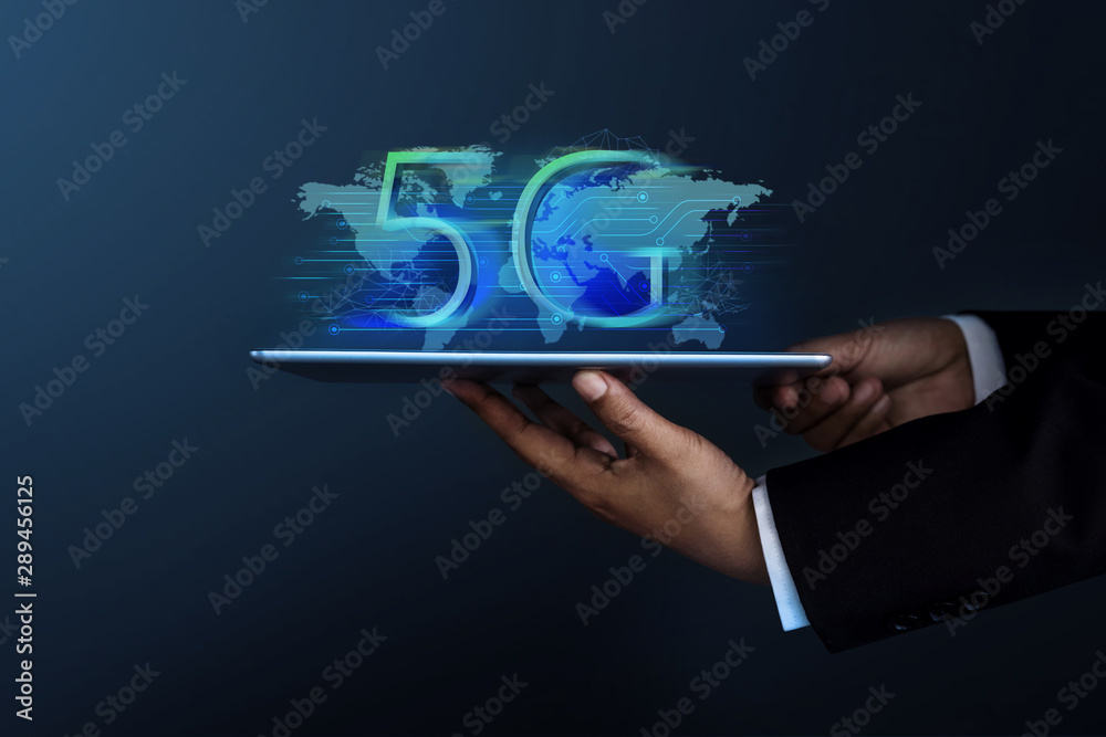 5G Network System Concept. Businessman in Formal Suit Holding a Digital Tablet for Present a New Technology of World Communication, Side view 5G Network System Concept. Businessman in Formal Suit Holding a Digital Tablet for Present a New Technology of World Communication, Side view