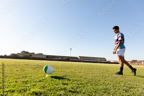 Young adult female rugby player on a rugby pitch photo