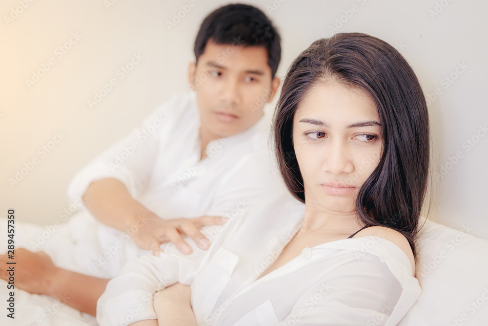 Frustrated young couple with serious relationship problems on the bed Frustrated young couple with serious relationship problems on the bed