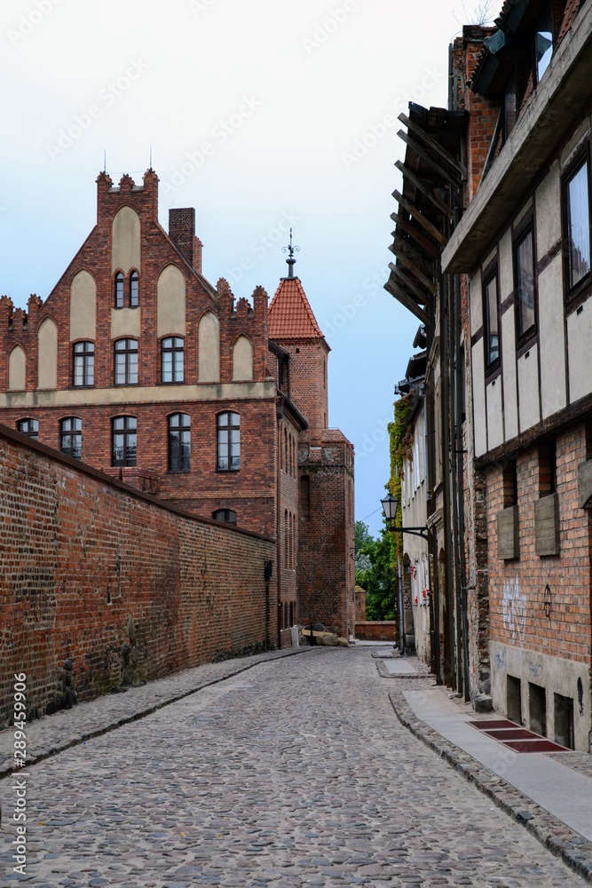 Narrow Podmurna street in medieval city of Torun, Poland.