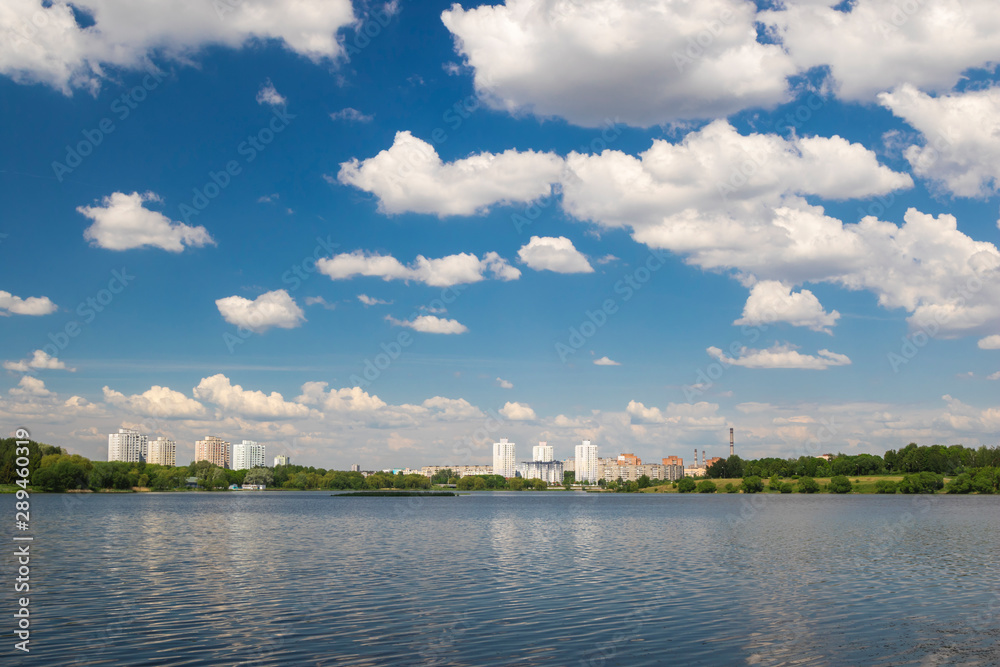 Naklejka premium Cumulonimbus clouds over lake, city lake in Minsk