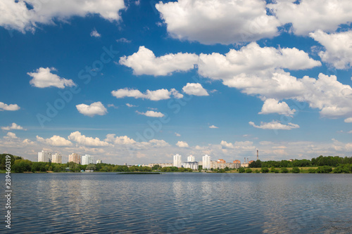 Cumulonimbus clouds over lake, city lake in Minsk