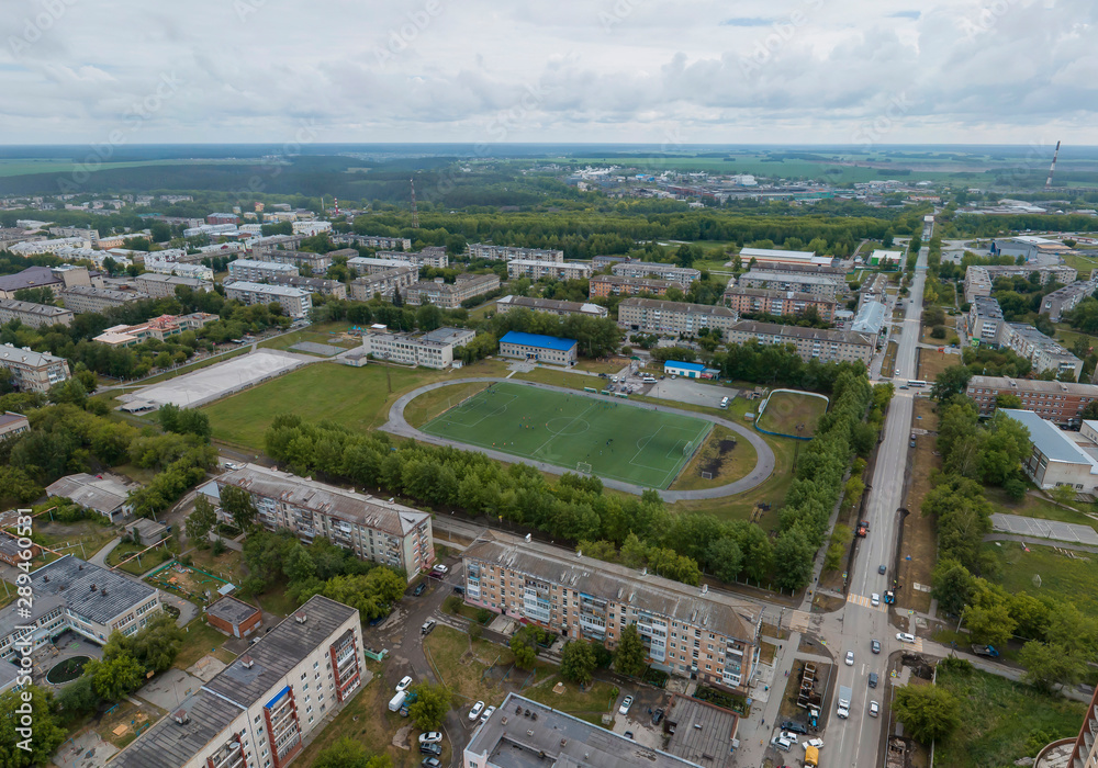 Stadium in Sukhoy Log city. Aerial, summer, cloudy day