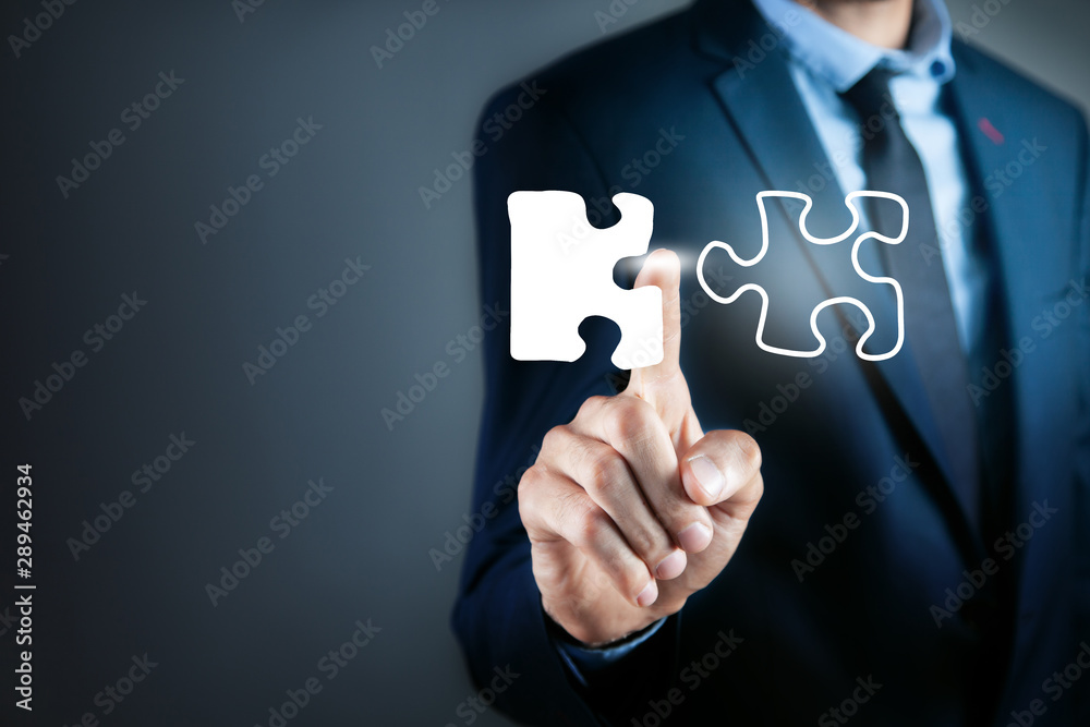 businessman presses puzzle in screen businessman presses puzzle in screen