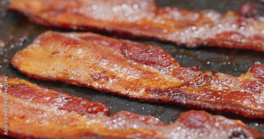 Fry bacon in pan in kitchen for breakfast Fry bacon in pan in kitchen for breakfast