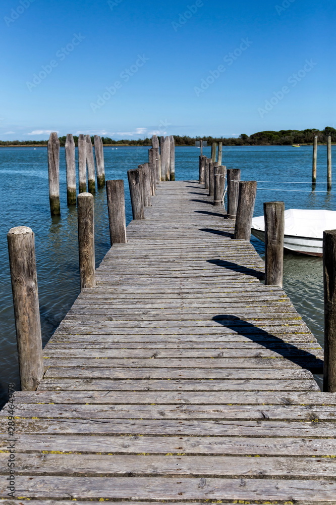 Fototapeta premium an old wooden landing stage at the sea