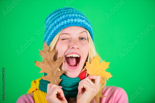 Time to rejuvenate and repair skin. How to update your skincare routine for autumn. Autumn skincare tips. Skincare and beauty tips. Healthy skin. Woman cute face wear knitted hat hold fallen leaves