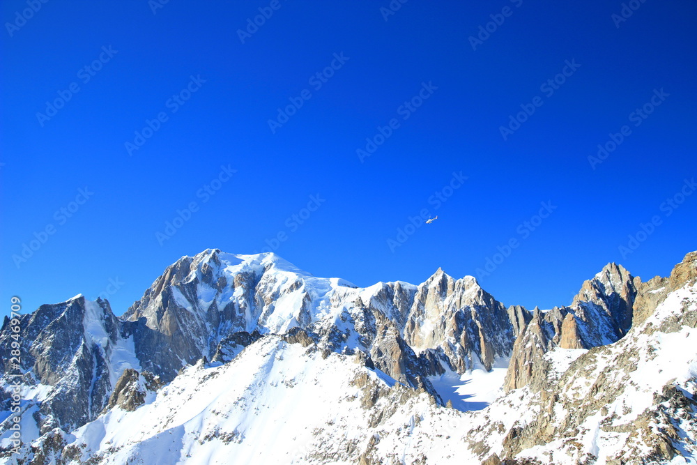 Mont Blanc, highest peak in Alps. Beautiful mountain landscape in winter with high snow and blue sky.