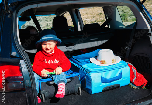 family car travel - little baby with suitcases and backpack