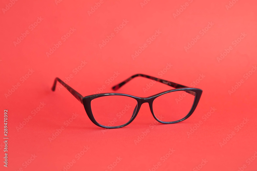 Fashionable stylish glasses on red background. Optics. Vision. Fashionable stylish glasses on red background. Optics. Vision.