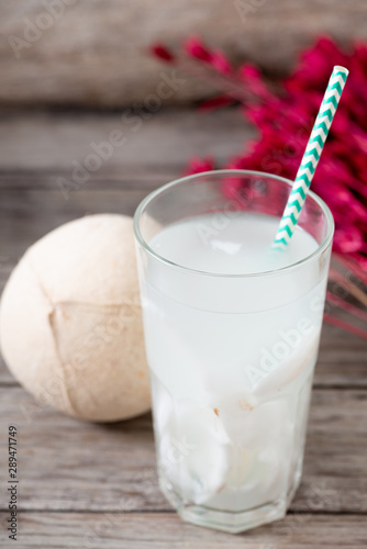 Fresh coconut juice in a glass with coconut white meat isolated on white