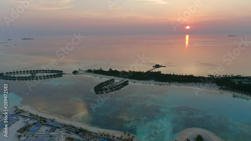 Aerial view, flight at  island Olhuveli and Bodufinolhu at dusk, South Male Atoll, Maldives photo