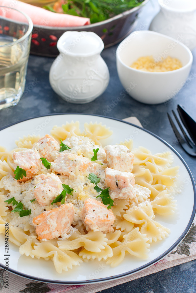 Farfalle with salmon in a creamy sauce, selective focus Farfalle with salmon in a creamy sauce, selective focus