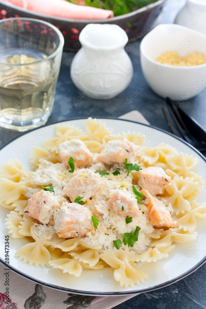Farfalle with salmon in a creamy sauce, selective focus Farfalle with salmon in a creamy sauce, selective focus