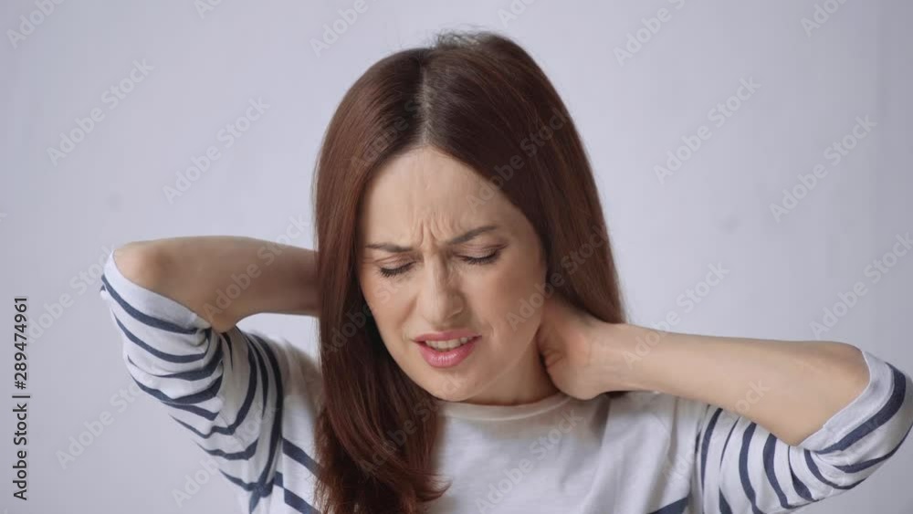 painful woman in striped top suffering from neck pain painful woman in striped top suffering from neck pain