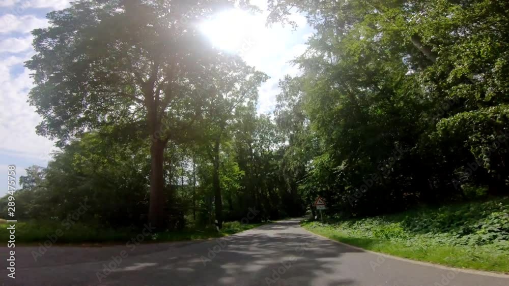 P.O.V. - Driving on a rural road in the northern germany. 4K Video footage from a On-board camera P.O.V. - Driving on a rural road in the northern germany. 4K Video footage from a On-board camera