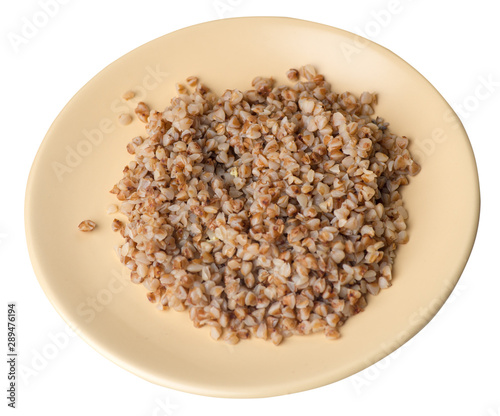 buckwheat in a plate isolated on white background. buckwheat top view. photo