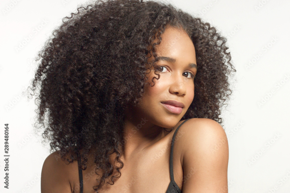 closeup portrait of young mixed race model with curly hair in studio with  natural neutral makeup with big afro hair on white Stock Photo | Adobe Stock