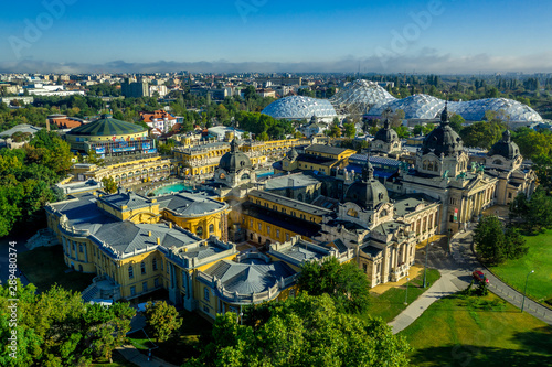 Aerial view of Szechenyi thermal spa with azure pool and the futuristic domes of the zooin the middle of Varosliget the green soul of Budapest Hungary