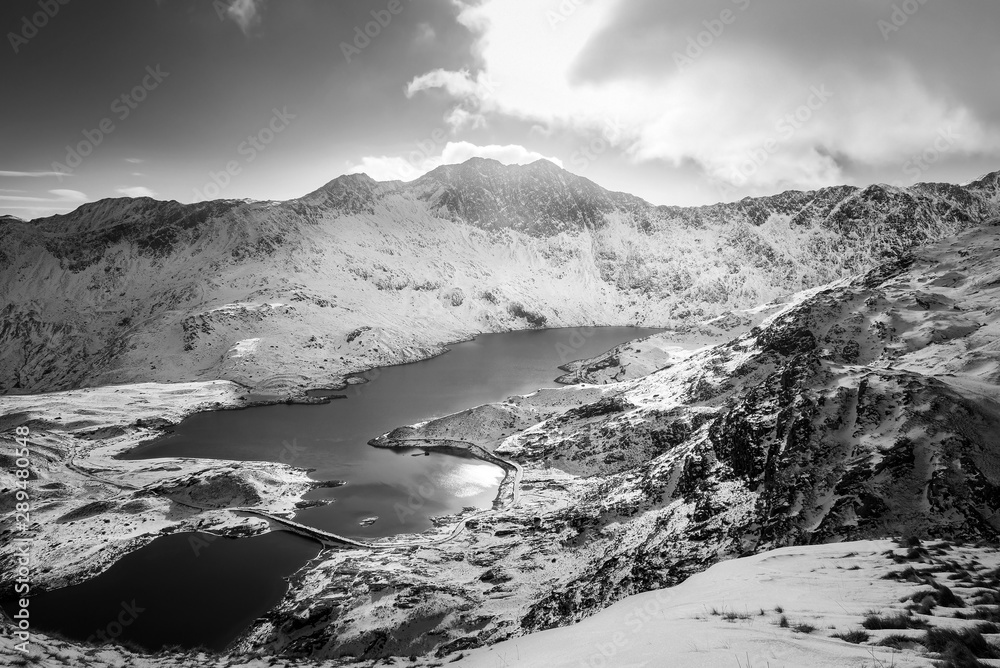 Snow covered mountain range and blue lakes in snowdonia, wales, United Kingdom.