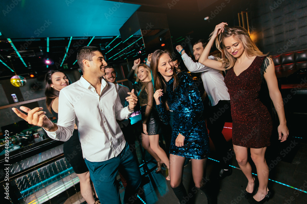 Group of friends partying in a nightclub
