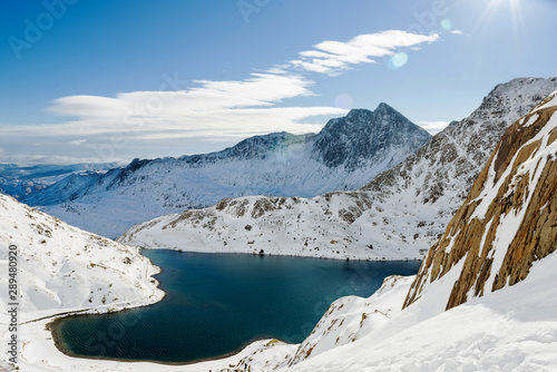 Snow covered mountain range and blue lakes in snowdonia  wales  United Kingdom.