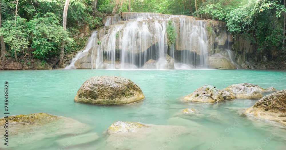 Naklejka premium Waterfall in rain forest at Erawan National Park at Kanchanaburi in Thailand