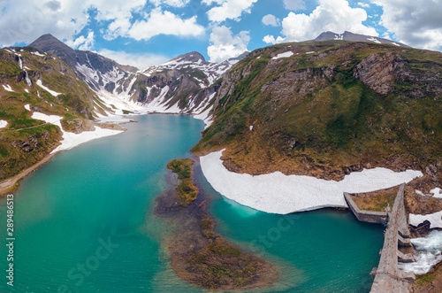 Aerial top view point of Grossglockner Hochalpenstrasse Alpine Road in Austria, summer day. Motorcyclists and travelers road. (Nassfeldspeicher, Margaritzenstausee, Heiligenblut lake) photo