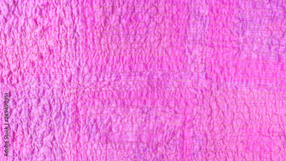 Fototapeta premium pink textured surface of scarf from crushed cotton