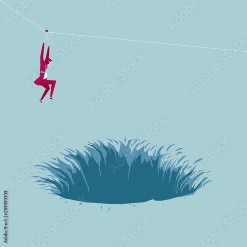 Businessman fleeing the danger using a pulley. Isolated on blue background.
