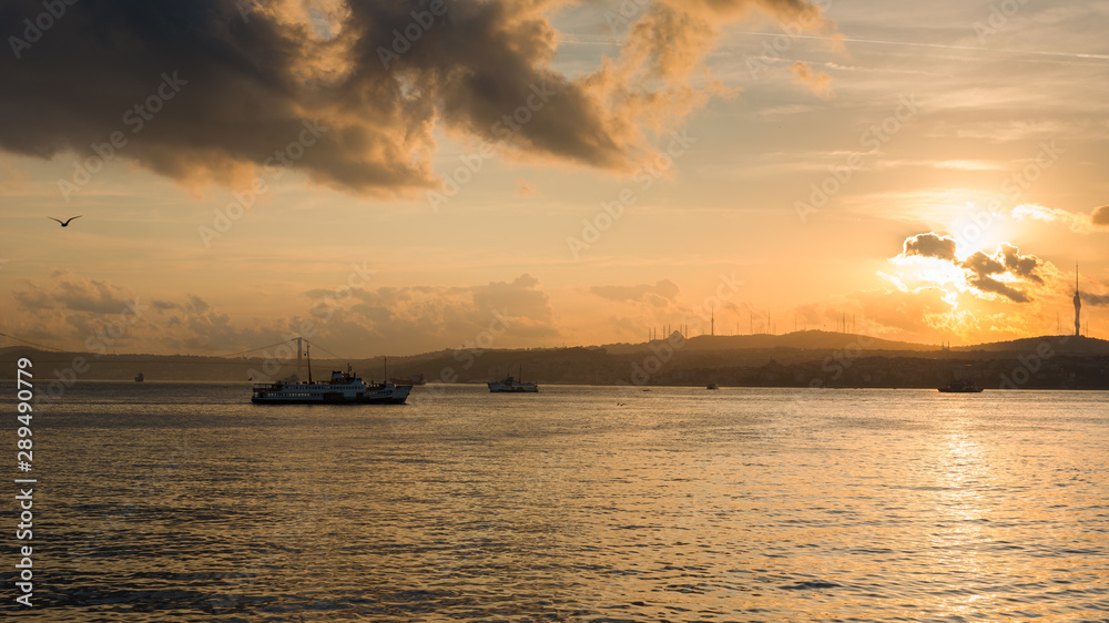Istanbul Bosphorus view from Galata Bridge at sunrise. Passenger ferries and maritime traffic