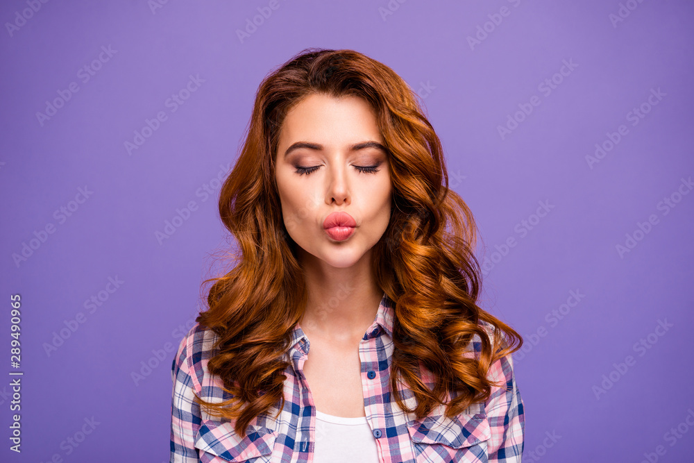Close up photo of pretty ginger lady in flirty mood sending handsome guy air kiss wear checkered casual shirt isolated purple color background Close up photo of pretty ginger lady in flirty mood sending handsome guy air kiss wear checkered casual shirt isolated purple color background