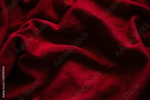Red fall sweater texture. Autumn cozy cloth concept. Textile background 