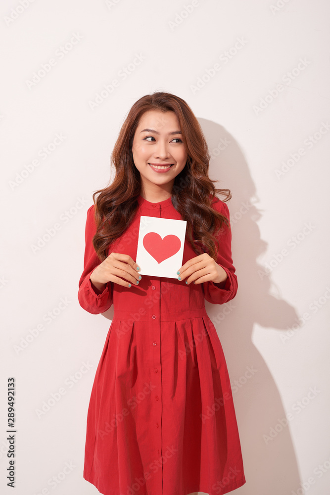 Portrait of happy romantic girl with red paper heart-shaped postcard, romantic wishes, Valentine day celebration, love concept Portrait of happy romantic girl with red paper heart-shaped postcard, romantic wishes, Valentine day celebration, love concept