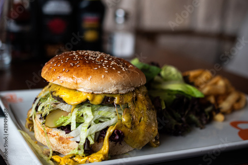 Cheeseburger with green salad and french fries
