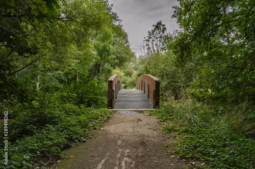 Small wooden bridge and steel on the river photo