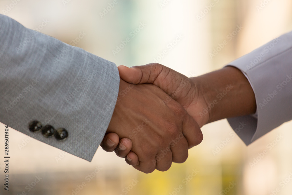 Closeup of business colleagues handshake. Business people greeting each other outside. Agreement concept