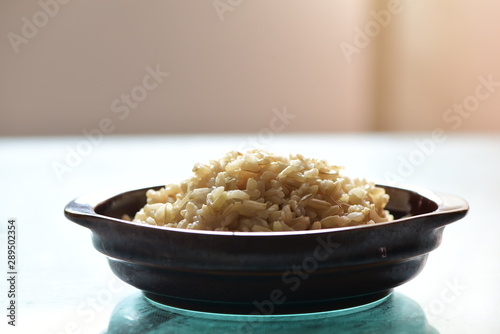 Cooked brown rice in the bowl on the dining table