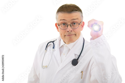 the doctor in a medical gown and a stethoscope on his shoulders looks closely and illuminates the flashlight. isolated background